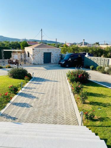 a driveway with a car parked in a parking lot at Villa Shangri-La Zakinthos in Zakynthos Town