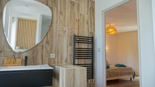 a bathroom with a mirror and a sink and a tub at VILLA MAGNOLIA in Montpellier