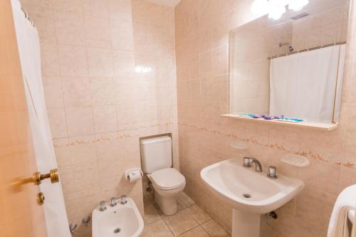 a bathroom with a toilet and a sink at Hotel Astor in Mar del Plata