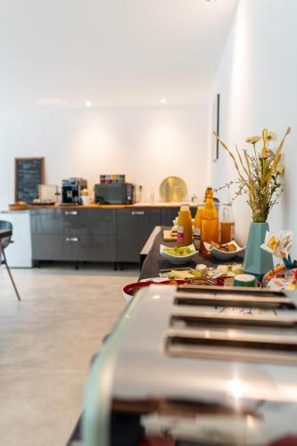 a kitchen with a table with plates of food on it at VILLA MAGNOLIA in Montpellier