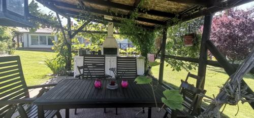 a picnic table in a yard with pink shoes on it at Noé Bárkája Vendégház in Nagyrákos