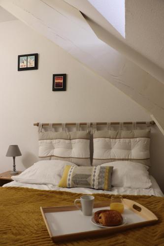 a tray with a plate of food on a bed at St Lary-VignecT3+ 3* rénové 8 pers. wifi+piscine in Vignec