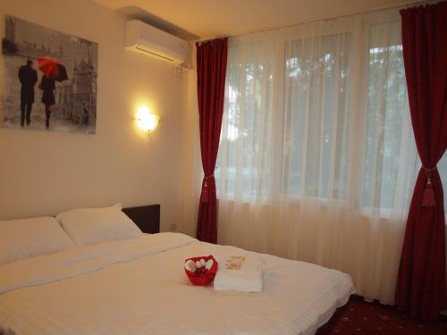 a hotel room with a bed with a box on it at Hotel Marie in Mamaia