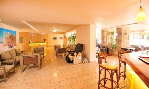 
a living room filled with furniture and a kitchen at Carina Hotel in Rhodes Town
