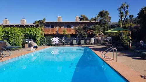 a large blue swimming pool in front of a building at Carmel Valley Lodge in Carmel Valley