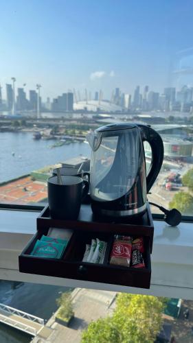a tray with a tea kettle on top of a table at London ExCeL Stays in London