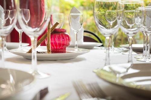 a table with wine glasses and a plate of food at Hotel Arha Mar Comillas in Comillas