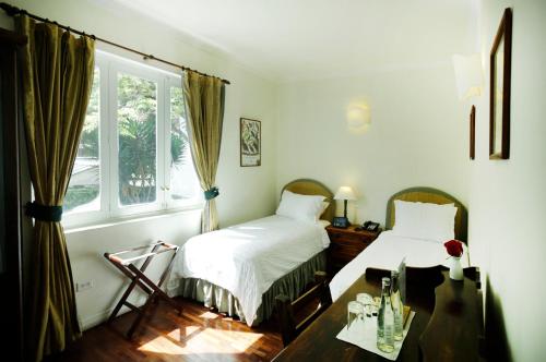 Postel nebo postele na pokoji v ubytování La Rabida Hotel Boutique