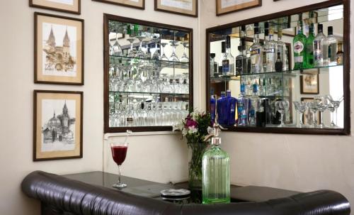 a bar with a bottle of wine and a glass at La Rabida Hotel Boutique in Quito