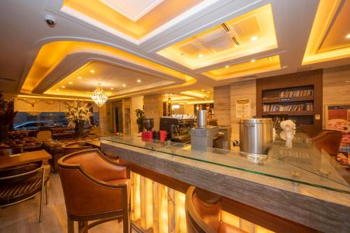 a lobby with a bar with stools at Ramada By Wyndham Istanbul Pera Taksim in Istanbul