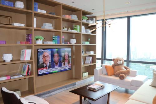 a living room with a tv on a wall at Crowne Plaza Shenzhen Nanshan by IHG in Shenzhen