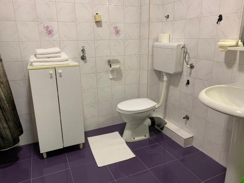 a bathroom with a toilet and a sink at Happy M&S 2 in Šabac