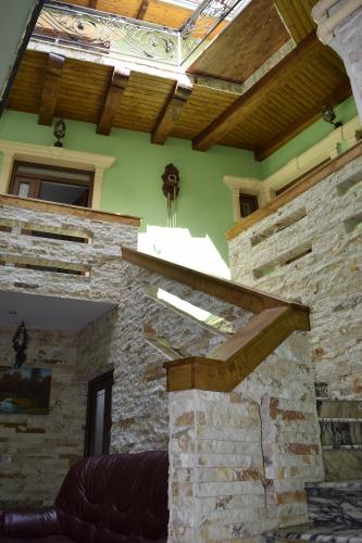 a building with a wooden roof and a stone wall at Pensiunea Nobil Medieval in Sighişoara