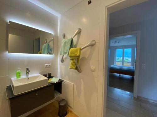 a bathroom with a sink and a mirror at Appartement Schillerkopf in Bludenz