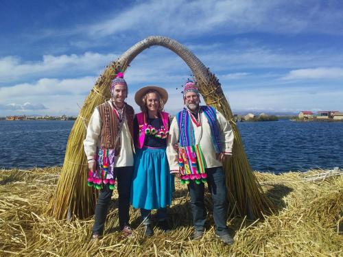 Lago Titicaca في بونو: مجموعة من ثلاثة أشخاص يقفون تحت قوس فوق الماء