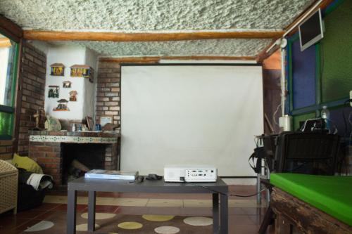 a living room with a white door and a table at La Cigarra Casa de Huéspedes in Salento