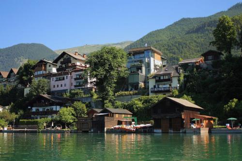 un grupo de casas a orillas de un lago en Pension Linortner en St. Wolfgang