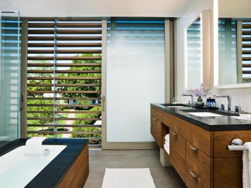 a bathroom with a sink and a large window at Topping Rose House in Bridgehampton