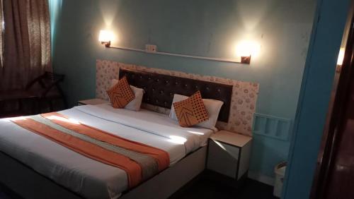a bedroom with a bed with two pillows on it at Hotel veersarthak residency in Hisār