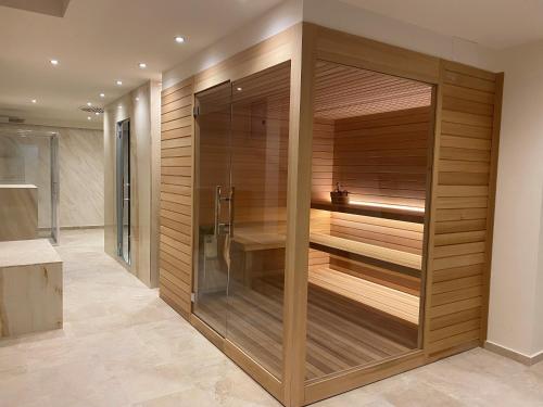 a sauna in a bathroom with wooden walls at Greif Hotel Maria Theresia in Trieste