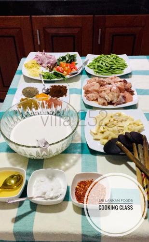 a table with many plates of food on it at Villa 252 Kosgoda in Kosgoda