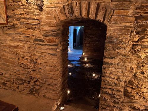 an archway in a stone wall with lights at VISPERBLICK 24-7 Parkplatz und Frühstück inkl in Ausserberg