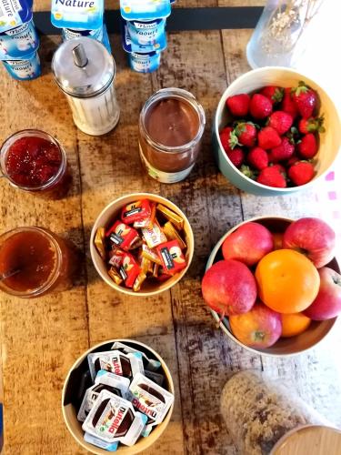 a group of bowls of fruits and vegetables on a table at 1861 Châtel Hostel in Châtel