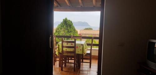 a room with a table and chairs on a balcony at Residence Spiaggia Bianca in Golfo Aranci