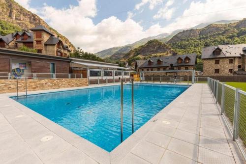 a swimming pool with mountains in the background at Los Altos de Escarrilla - tucasaenlospirineos in Escarrilla
