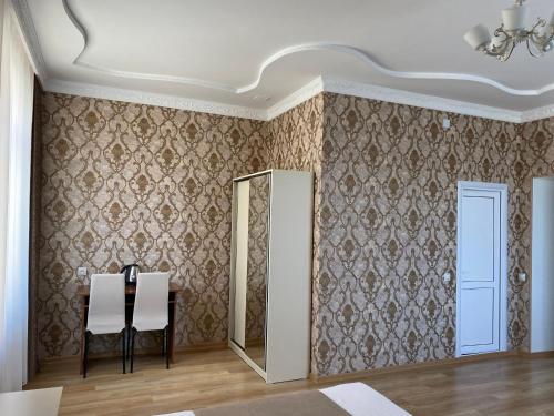 a dining room with a mirror and a table at Hotel Sharl in Ninotsminda