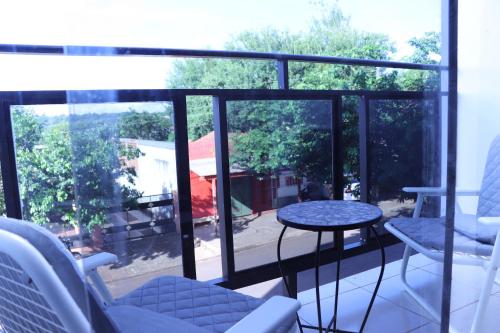 a balcony with a table and chairs and a view at WilMar Apart Hotel in Encarnación