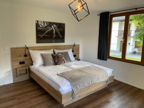 a bedroom with a large bed in a room with a window at Seaways Apartments in Schiefling am See