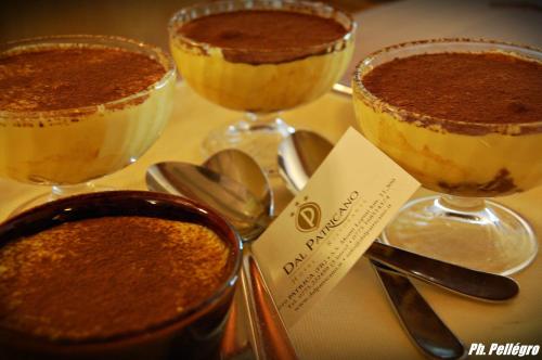 three desserts in glasses on a table with spoons at Dal Patricano in Frosinone
