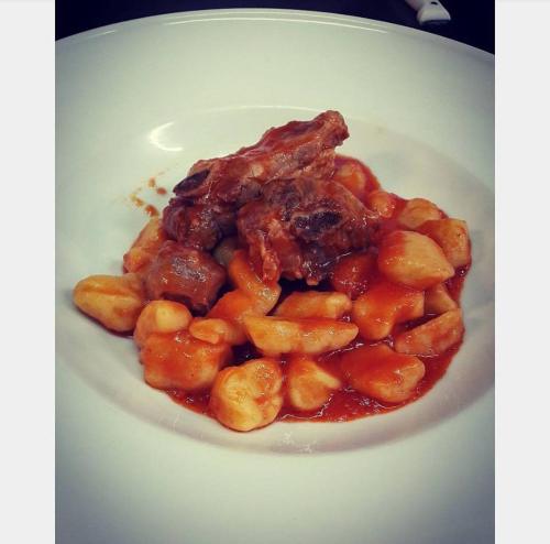 a white plate of food with beans and sauce at Dal Patricano in Frosinone