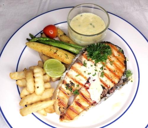 a plate of food with fish and french fries at Three Trees Samui Resort - Sarocha Villa in Lamai