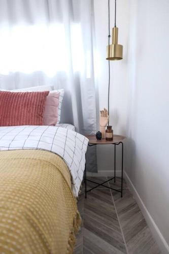 a bedroom with a bed and a side table at פינה בגליל in Maẕẕuva