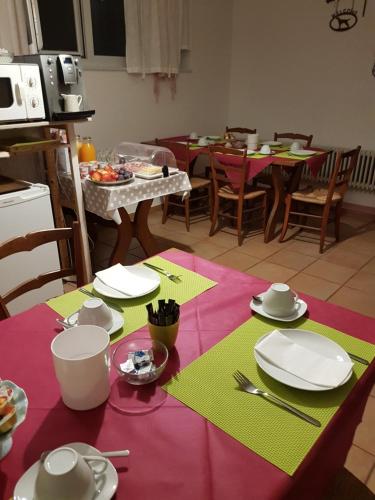 a kitchen with a table with plates and dishes on it at Garni Elisabetta in Gordola