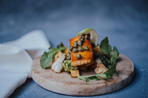a plate of food with fish and vegetables on a table at Termas El Corazon in San Esteban