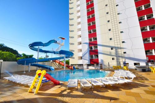 a swimming pool with a slide and a water park at Villas diRoma com um dia no Acqua Park, Splash e Slide in Caldas Novas