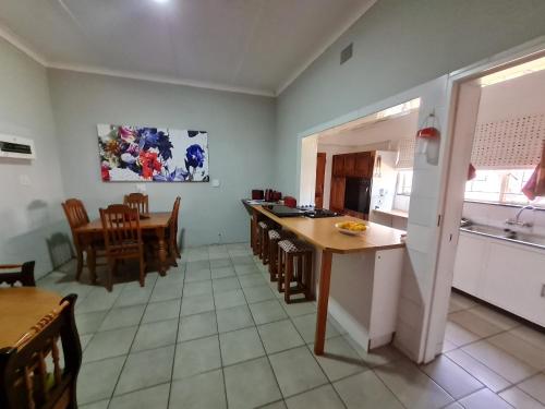 a kitchen and dining room with a table and chairs at The Garden Inn Guesthouse in Modimolle