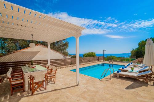 a patio with a table and chairs and a pool at Villa Daniela - Private Pool and Serene Location, by ZanteWize in Koríthion