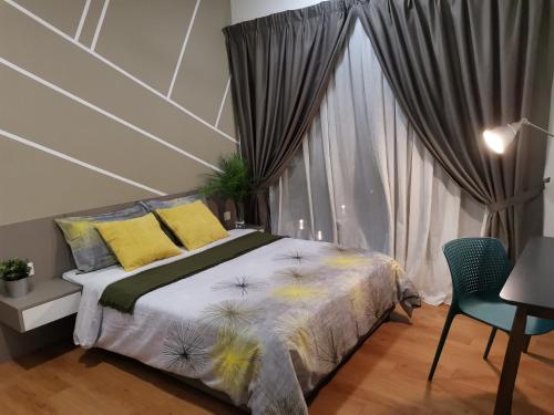 a bedroom with a bed with yellow pillows and a window at HIJAU Geniehome 2BR1studio Free 99mbps WIFI and Carpark at Utropolis Shah Alam in Shah Alam