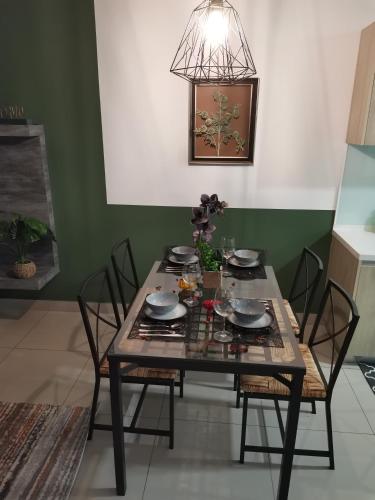 a dining room table with chairs and aendant light at HIJAU Geniehome 2BR1studio Free 99mbps WIFI and Carpark at Utropolis Shah Alam in Shah Alam