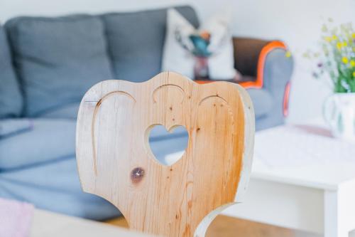 a wooden chair with a heart carved into it at Ferienwohnung Seilbahn in Sankt Gilgen