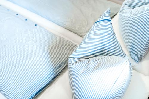 a bed with two pillows and a tie on it at Ferienwohnung Seilbahn in Sankt Gilgen