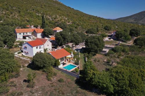 an aerial view of a house with a swimming pool at Holiday house Lovre in Prapatnica