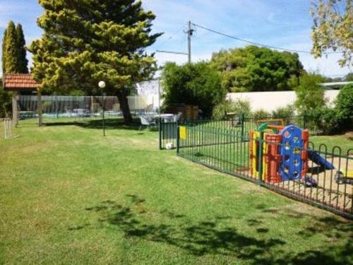 a playground in a yard with at Nicholas Royal Motel - No Pets Allowed in Hay