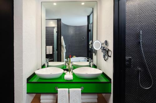 a bathroom with two sinks and a large mirror at Al Khoory Sky Garden Hotel in Dubai