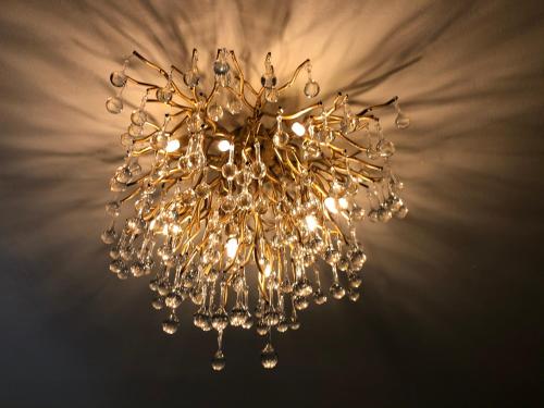 a gold chandelier hanging from a ceiling at Casa Del Castell in Carcassonne