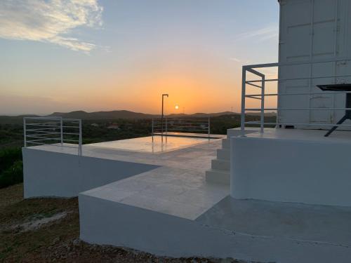 a building with a sunset in the background at FONTEINTop in Willemstad